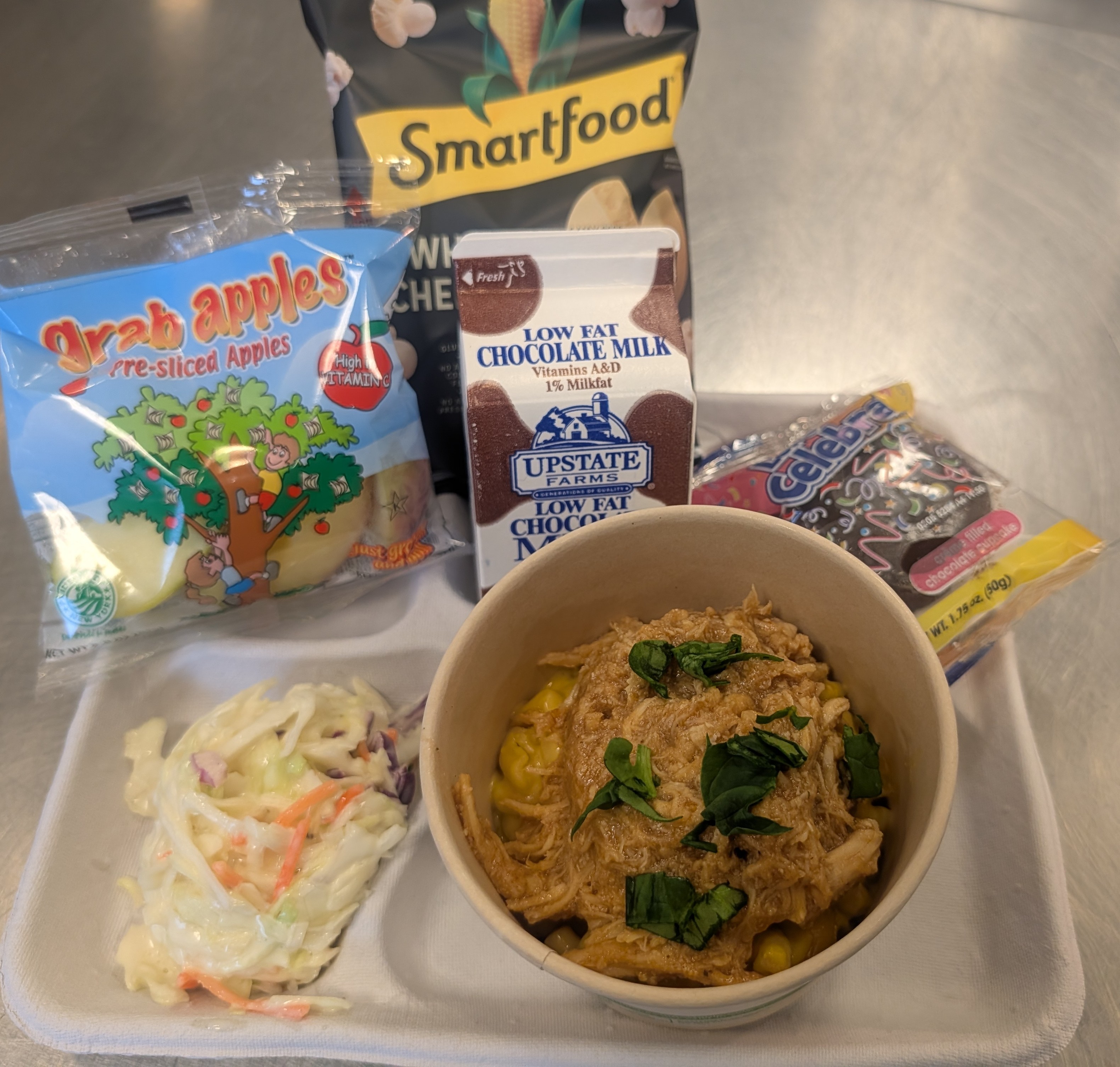 School 309- lunch served on 2.11.26 BBQ Chicken Mac and Cheese Bowl, Parmesan Cheese, apple slices, chocolate cupcake and chocolate milk