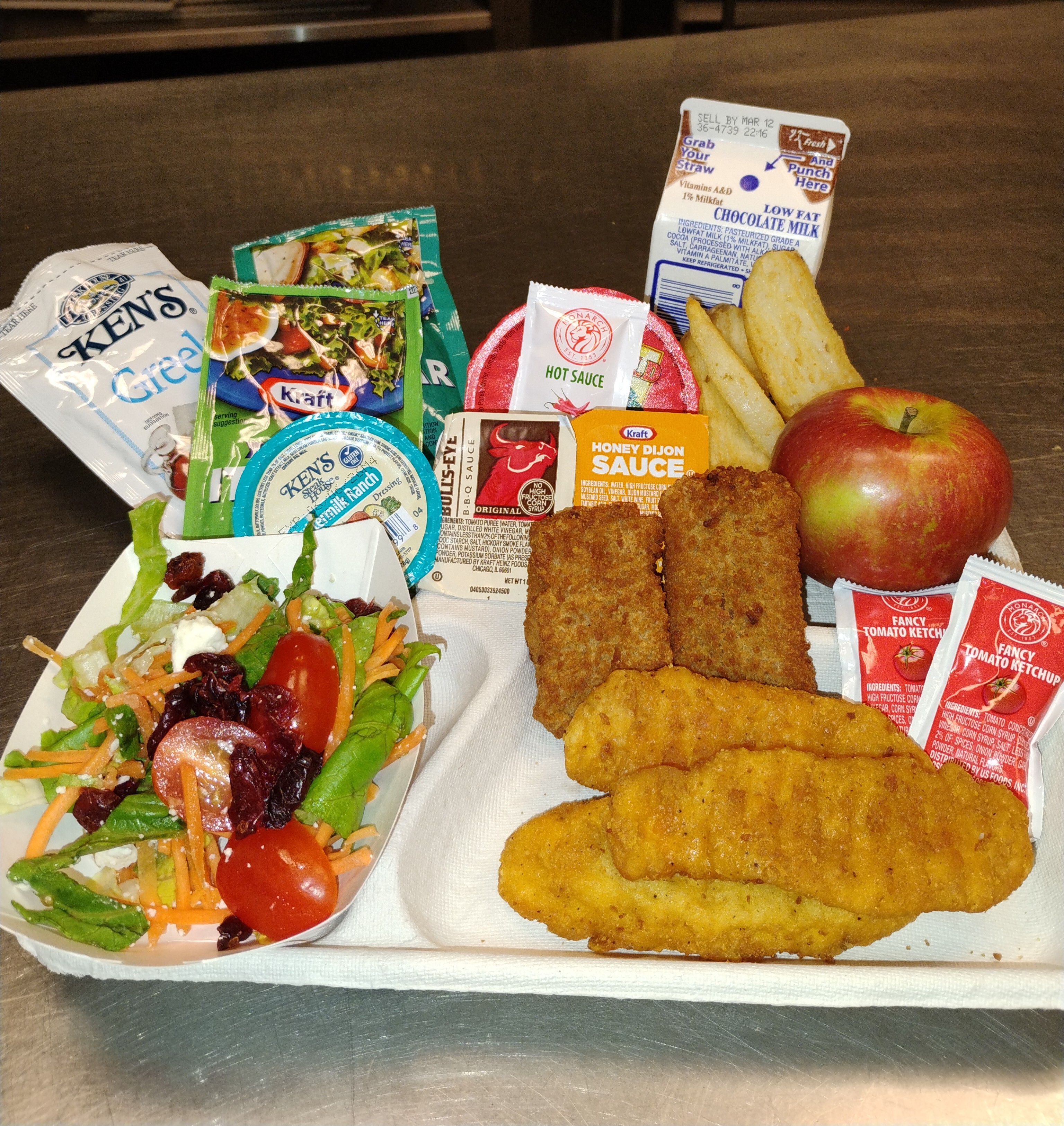 School 81- Lunch served on 3.6.26 ,Chicken tenders,  pizza crunchers, potatoes wedges, NY garden salad, apple and chocolate milk