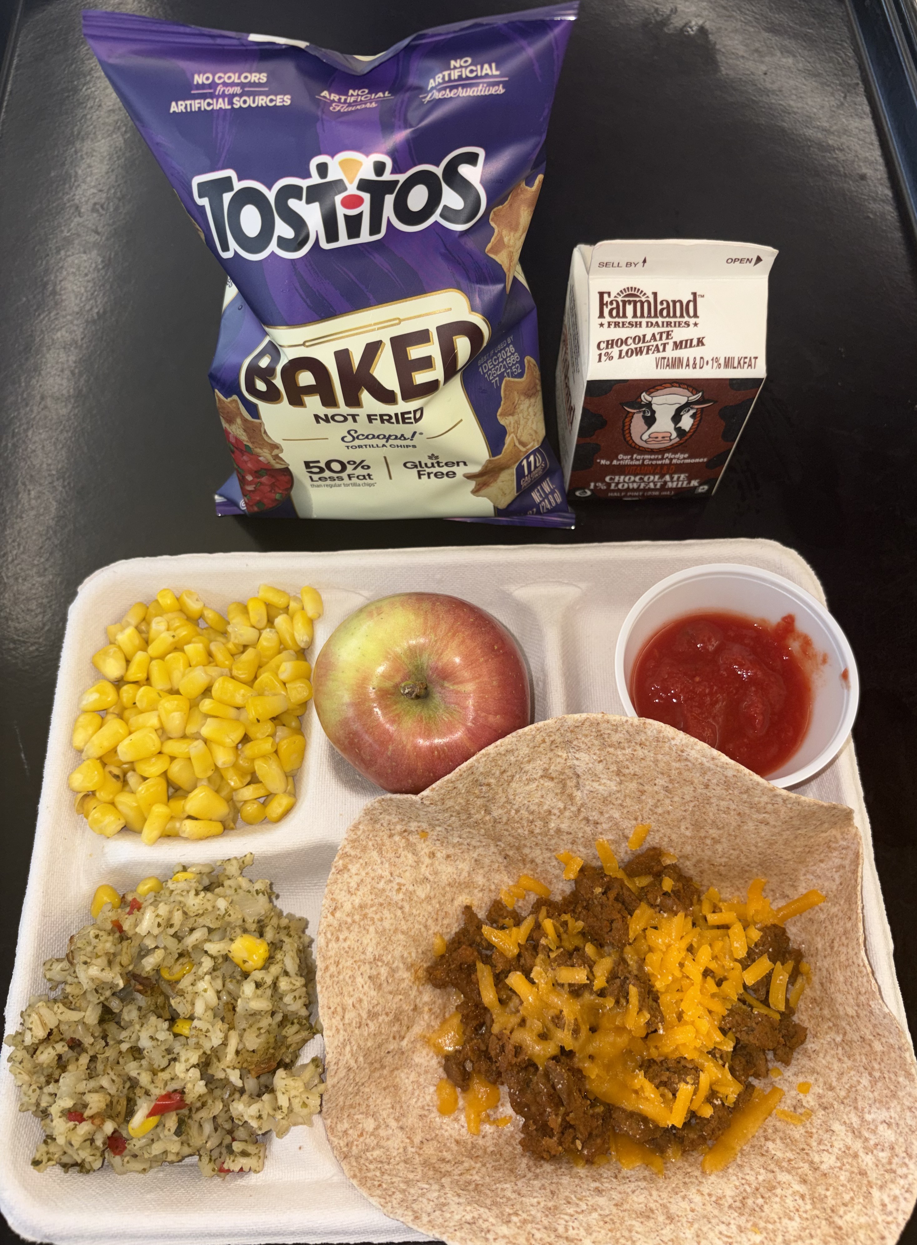 School 72- Lunch served on 9.9.26 Beef Taco Meat, Shredded Cheddar, Cilantro Rice, Wheat Tortilla, Sweet Corn, Salsa,Tostitos, Apple, Chocolate Milk