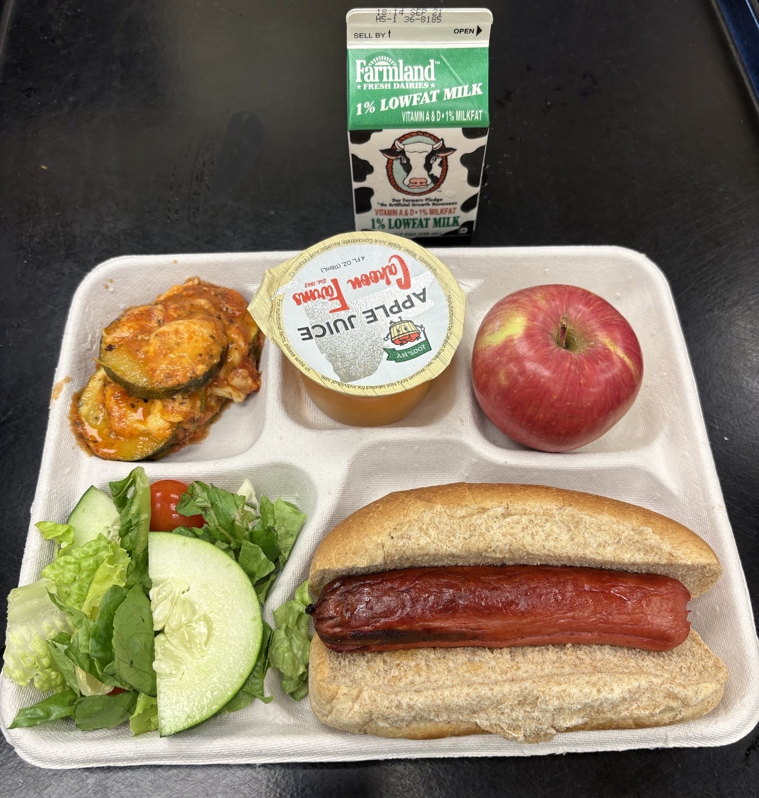 School 72- Lunch served on 9.10.26 NY Beef Hot Don on WG Bun, NY Zucchini Parmesan NY garden Salad, Cahoon Apple Juice, Apple & Milk