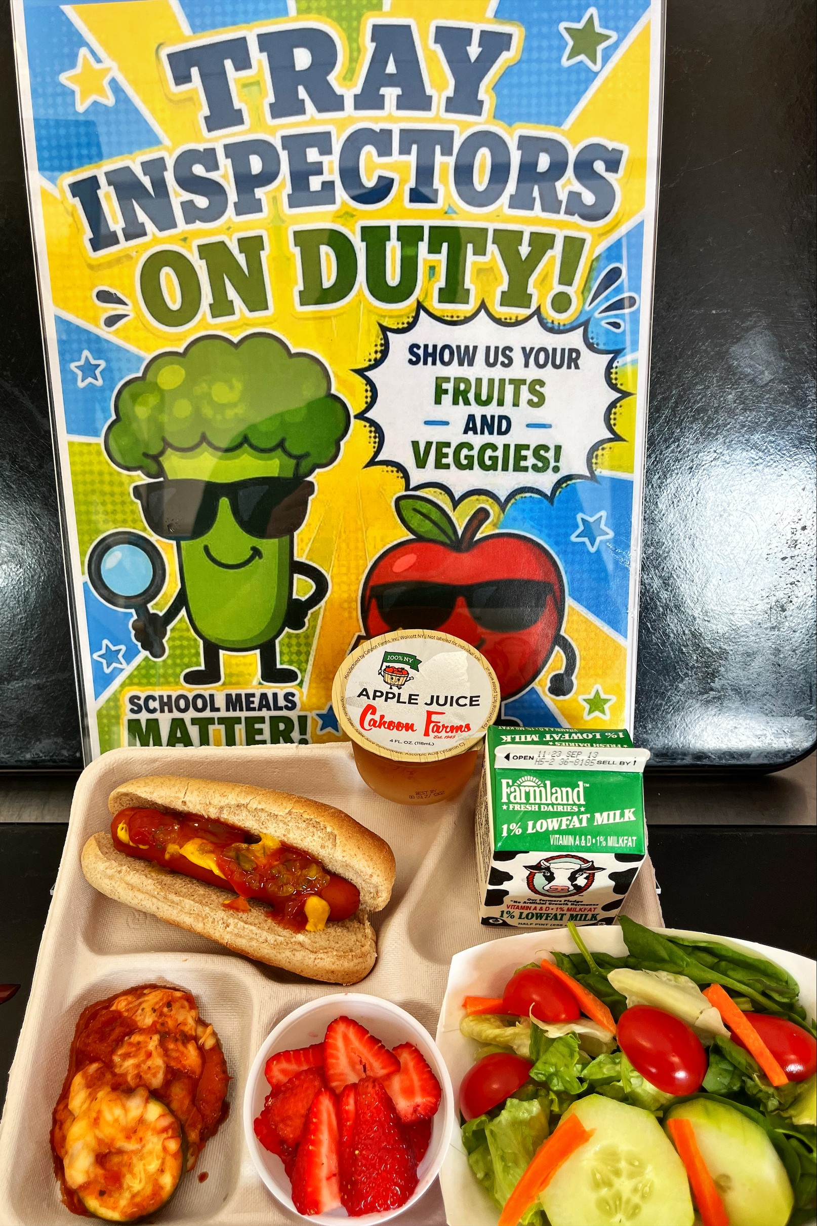School 363- Lunch served on 9.10.26 HALAL NY Beef Hot Don on WG Bun, NY Zucchini Parmesan NY garden Salad, Cahoon Apple Juice, Strawberries & Milk
