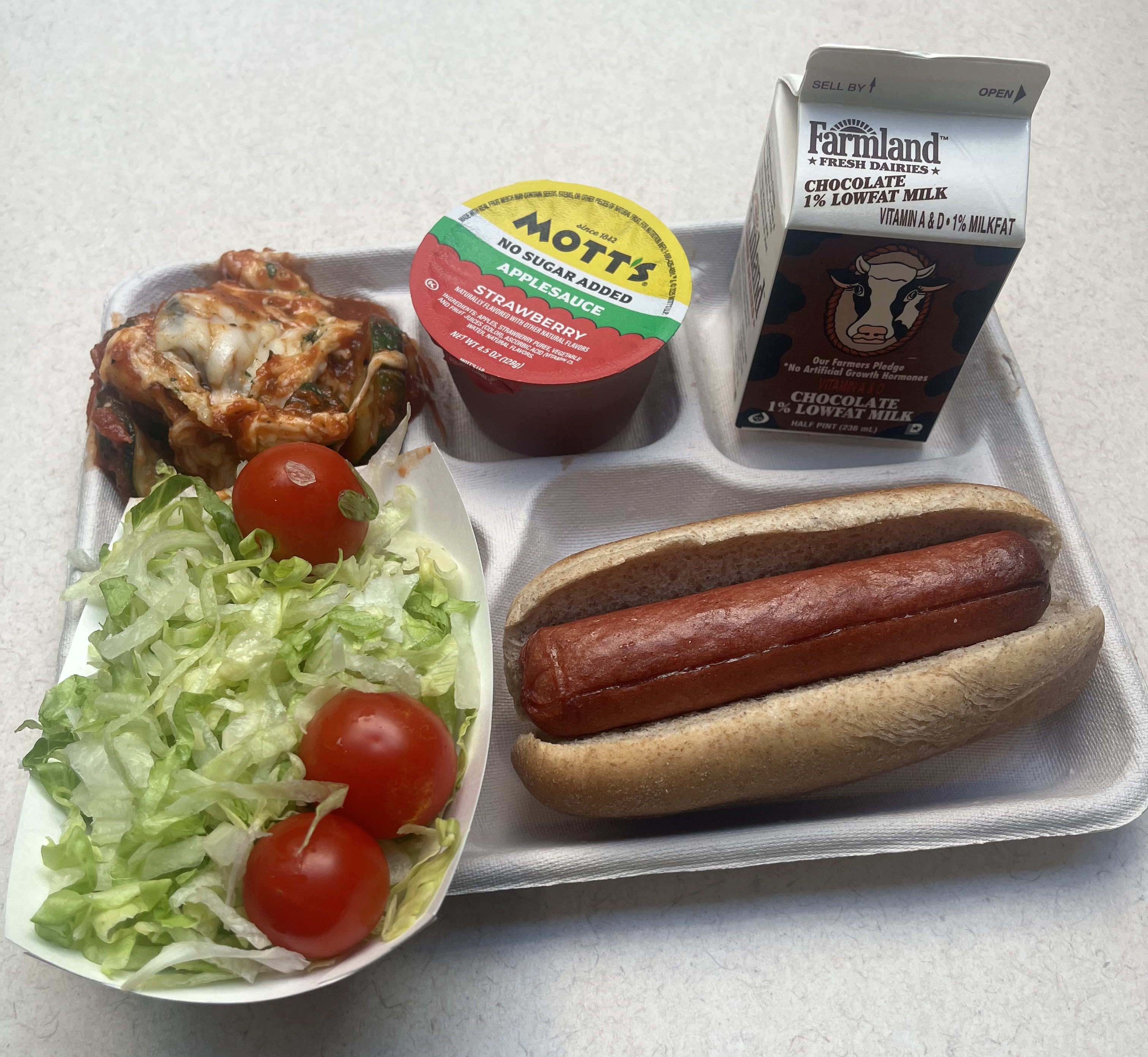 School 195- Lunch served on 9.10.26 NY Beef Hot Don on WG Bun, NY Zucchini Parmesan NY garden Salad, Apple Juice, Chocolate Milk