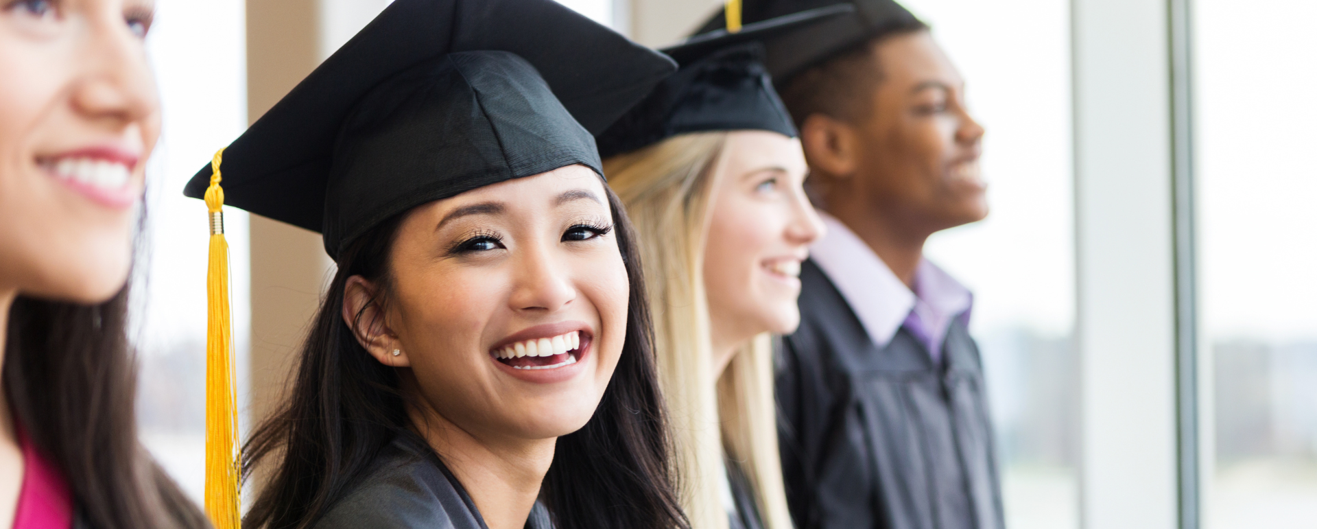 Student graduating and smiling