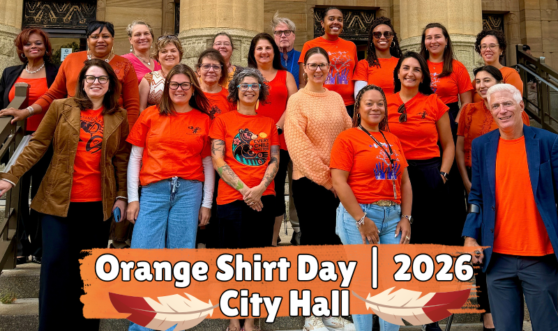 Staff from Buffalo City Hall wearing orange shirts while standing outside of City Hall