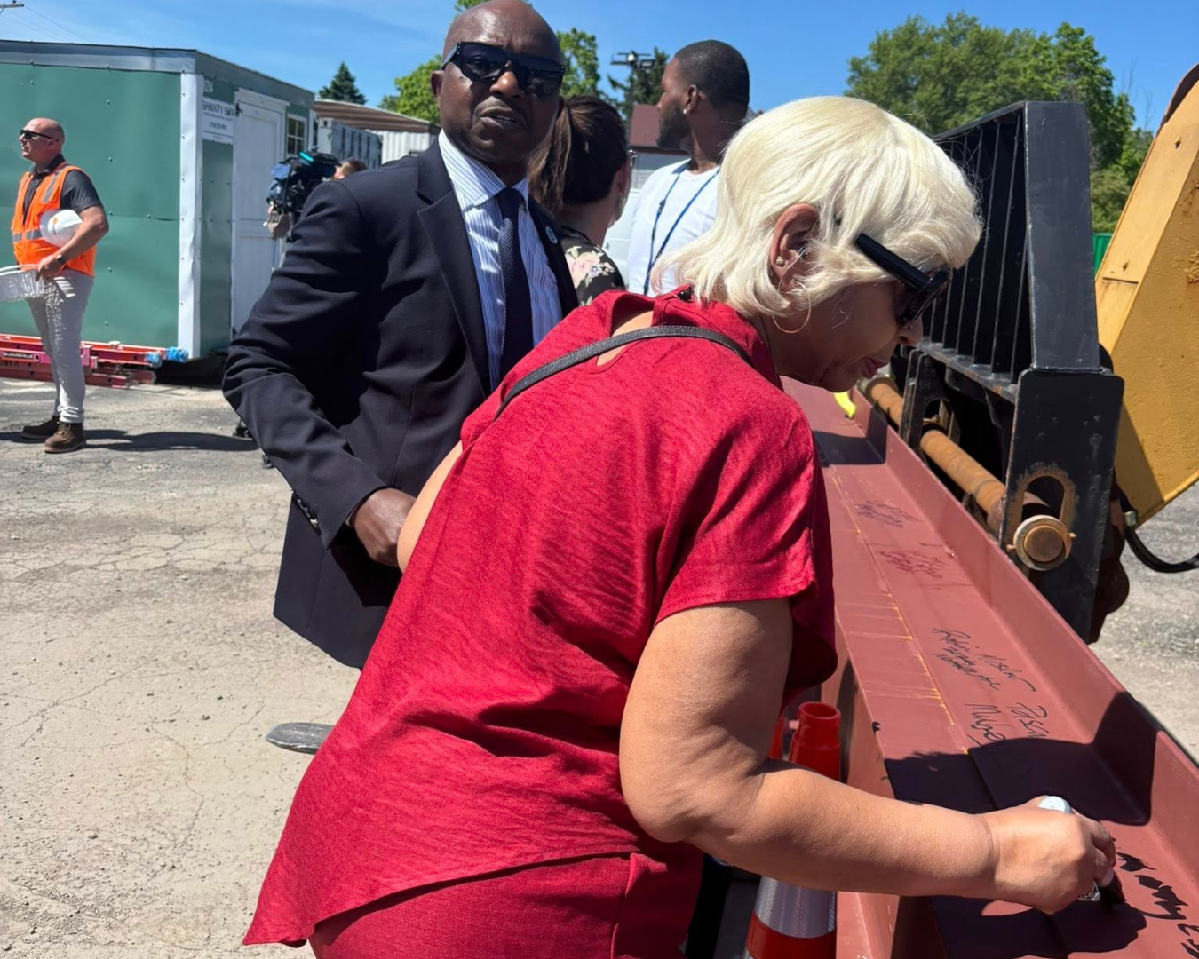 People signing steel beam