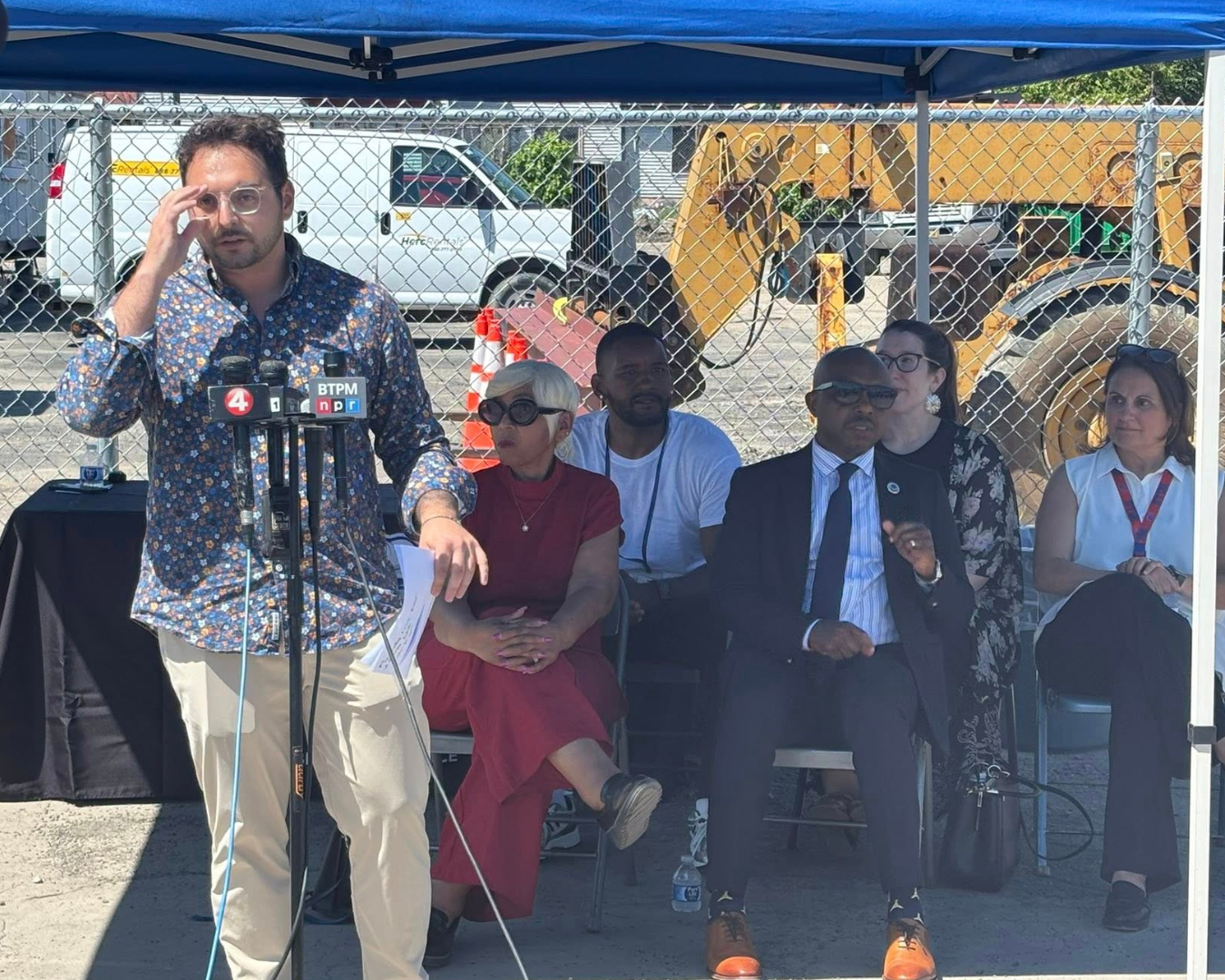 Person speaking on News Microphones