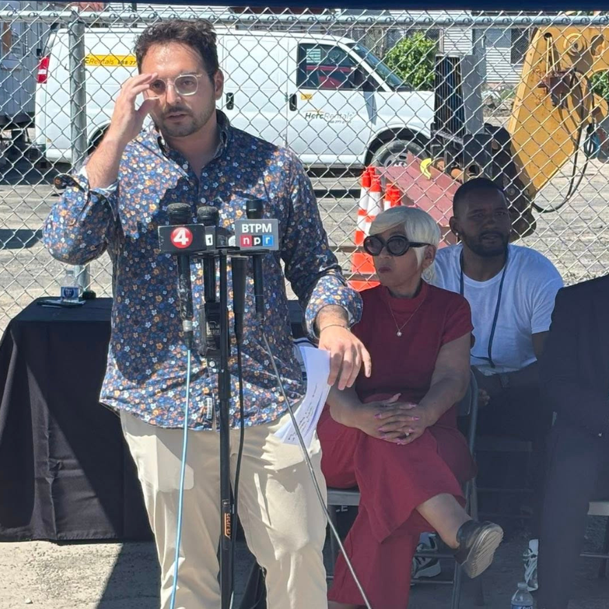 Person speaking on News Microphones