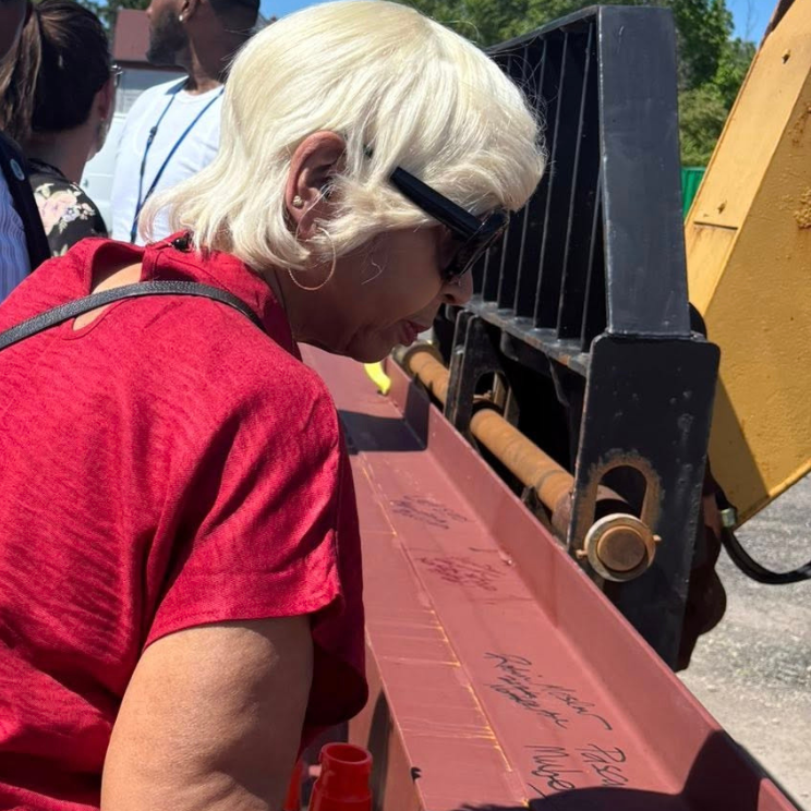 People signing steel beam