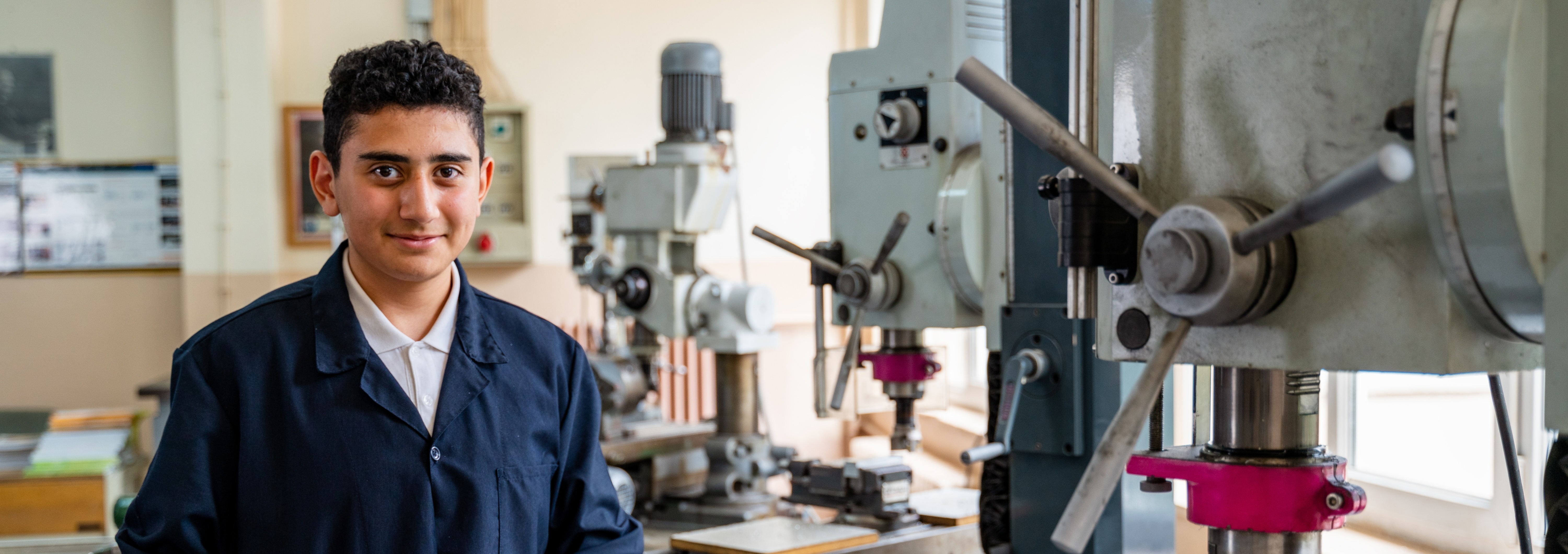 student next to a pilling machine