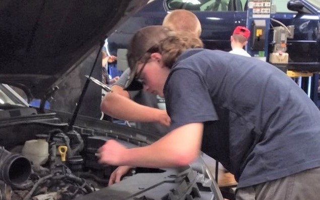 A man fixing a car