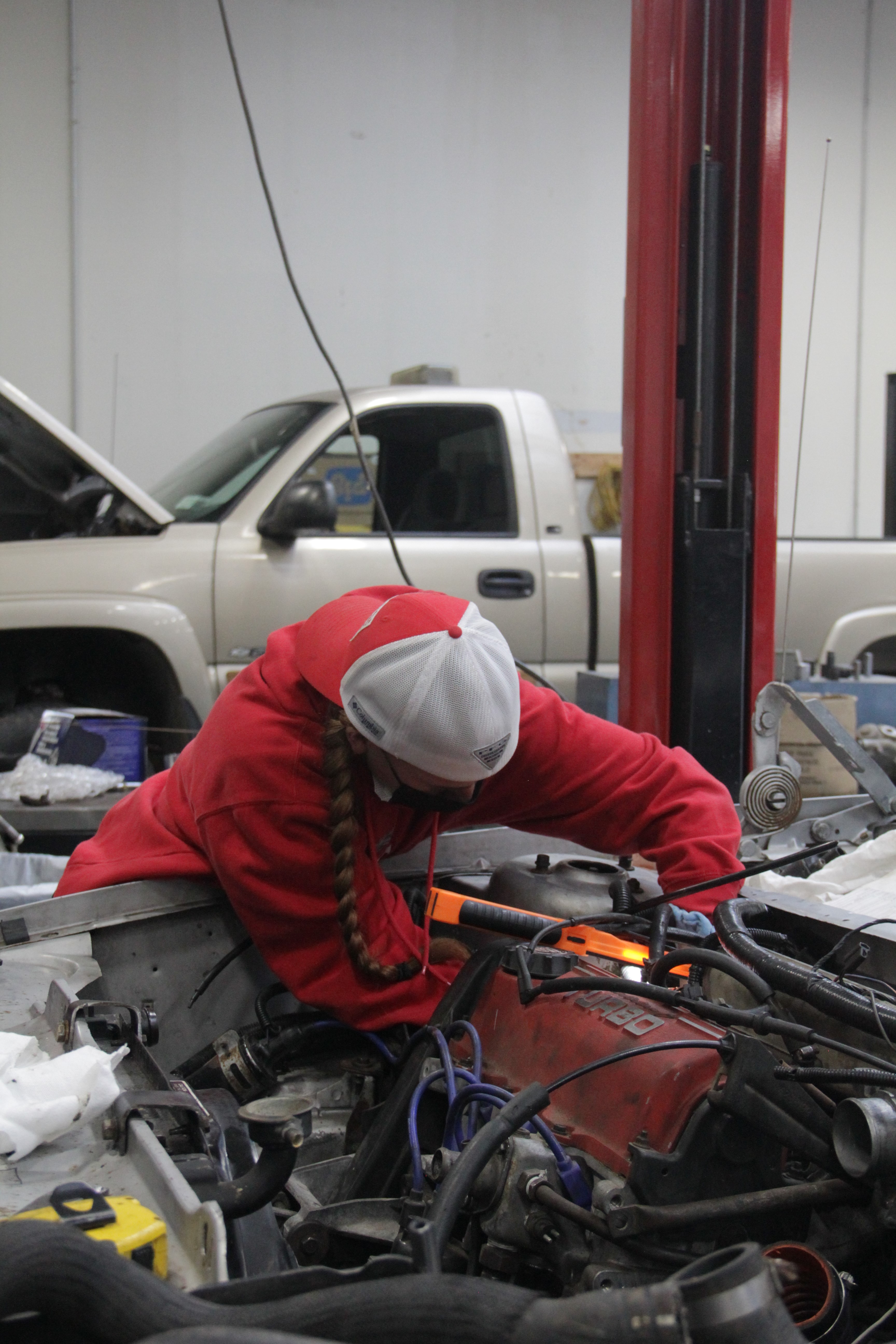 A girl is fixing a car