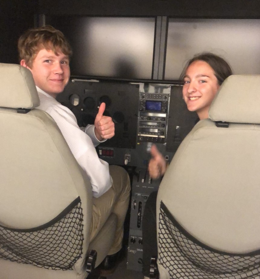 Two individuals in a flight simulator