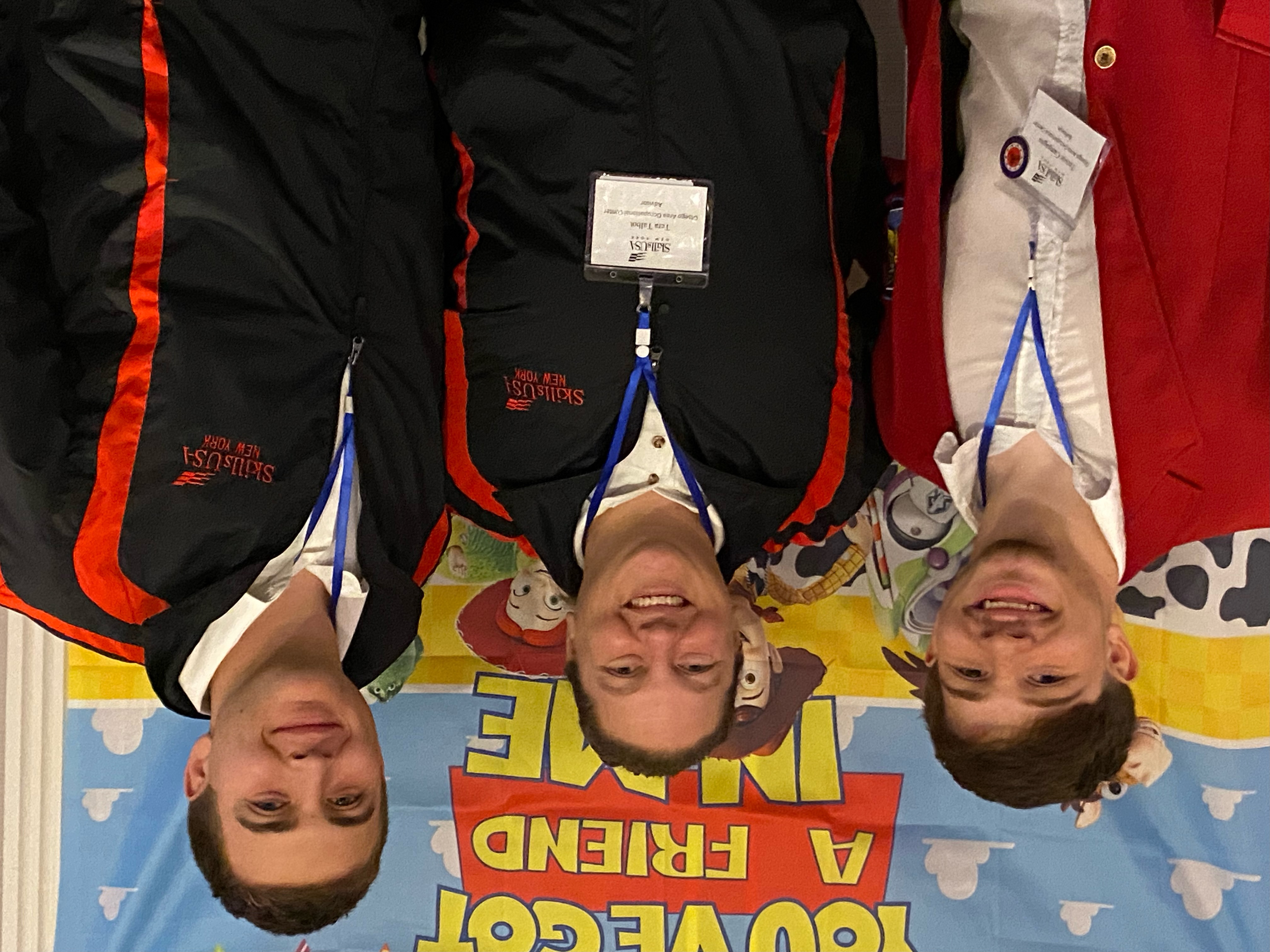 Three individuals posing for a photo