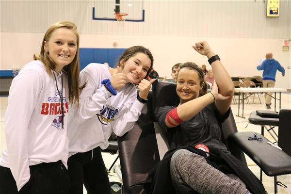 Three girls smiling showing inclusivity and friendship.