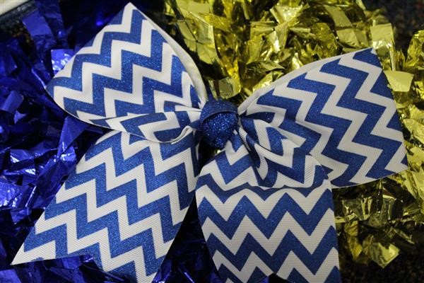 Cheerleading pom poms in blue and white with chevron pattern, perfect for adding spirit to any game or event.