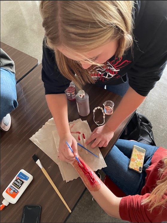 The First Aid class used moulage to make fake wounds and then practice different methods of controlling the "bleed" and checking patient vital signs.