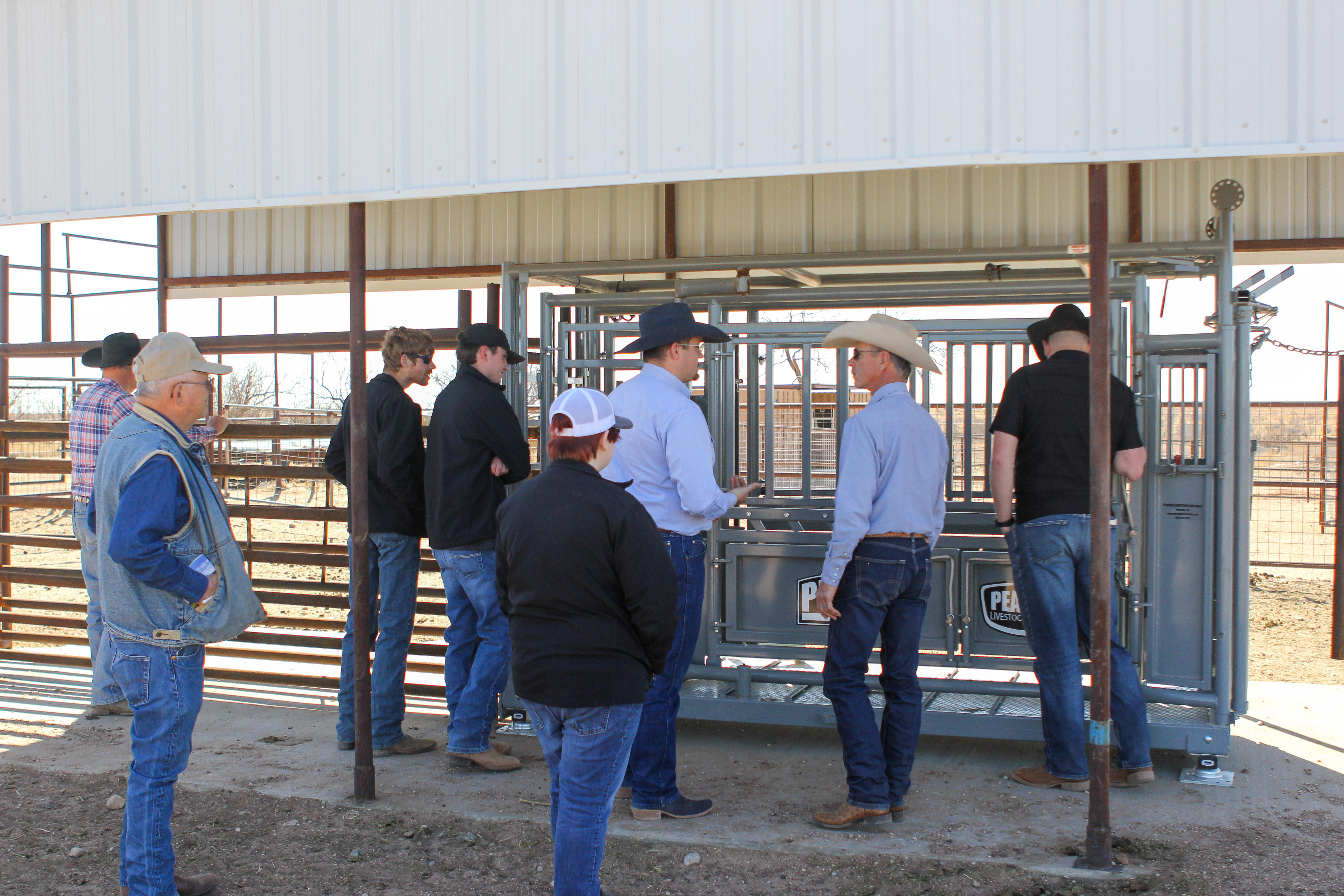 People talking outside of stables
