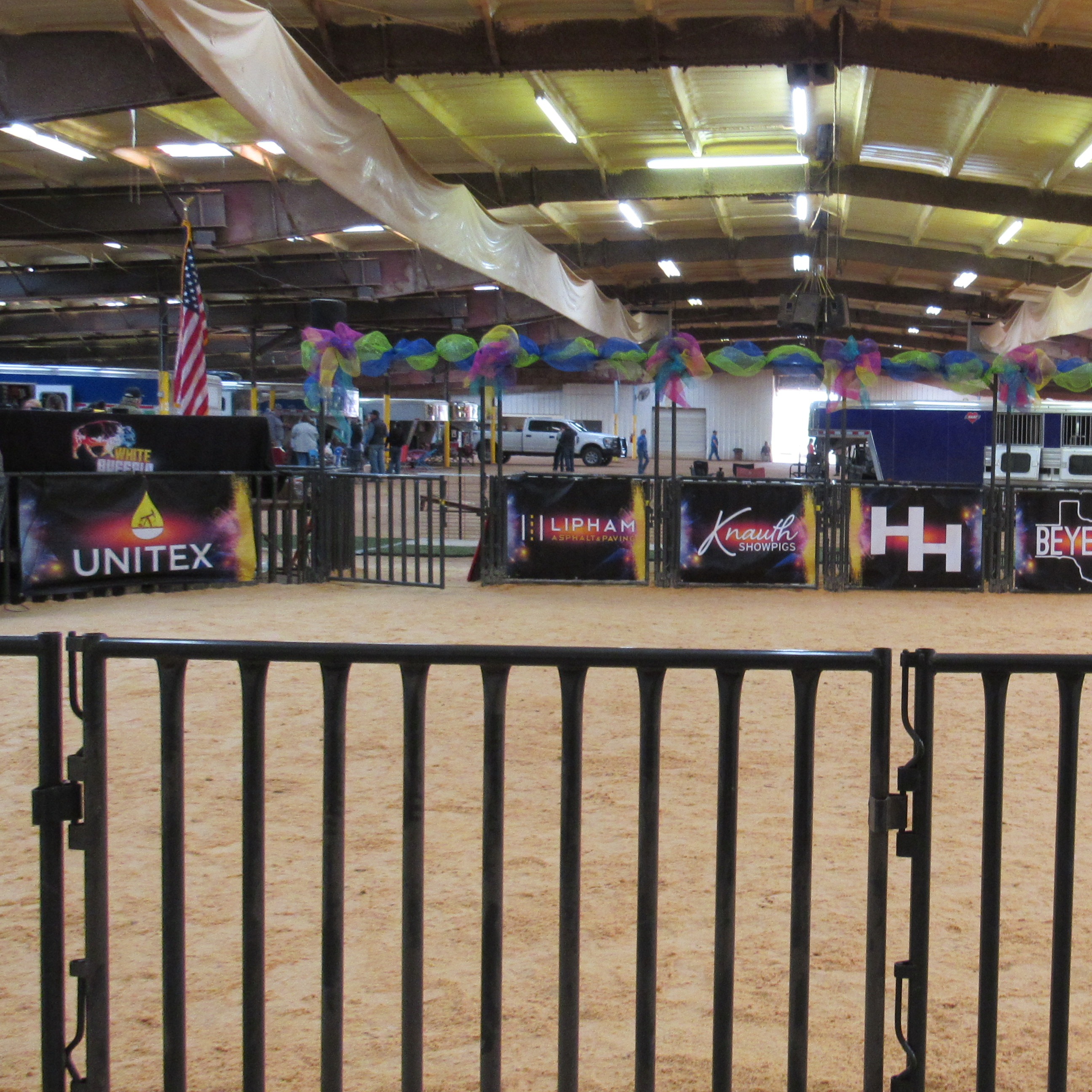 Stables with company sponsorship banners on fence