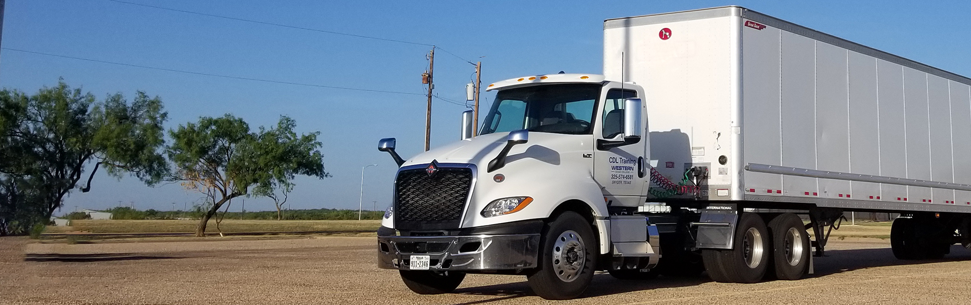 White semi truck in a parking lot.