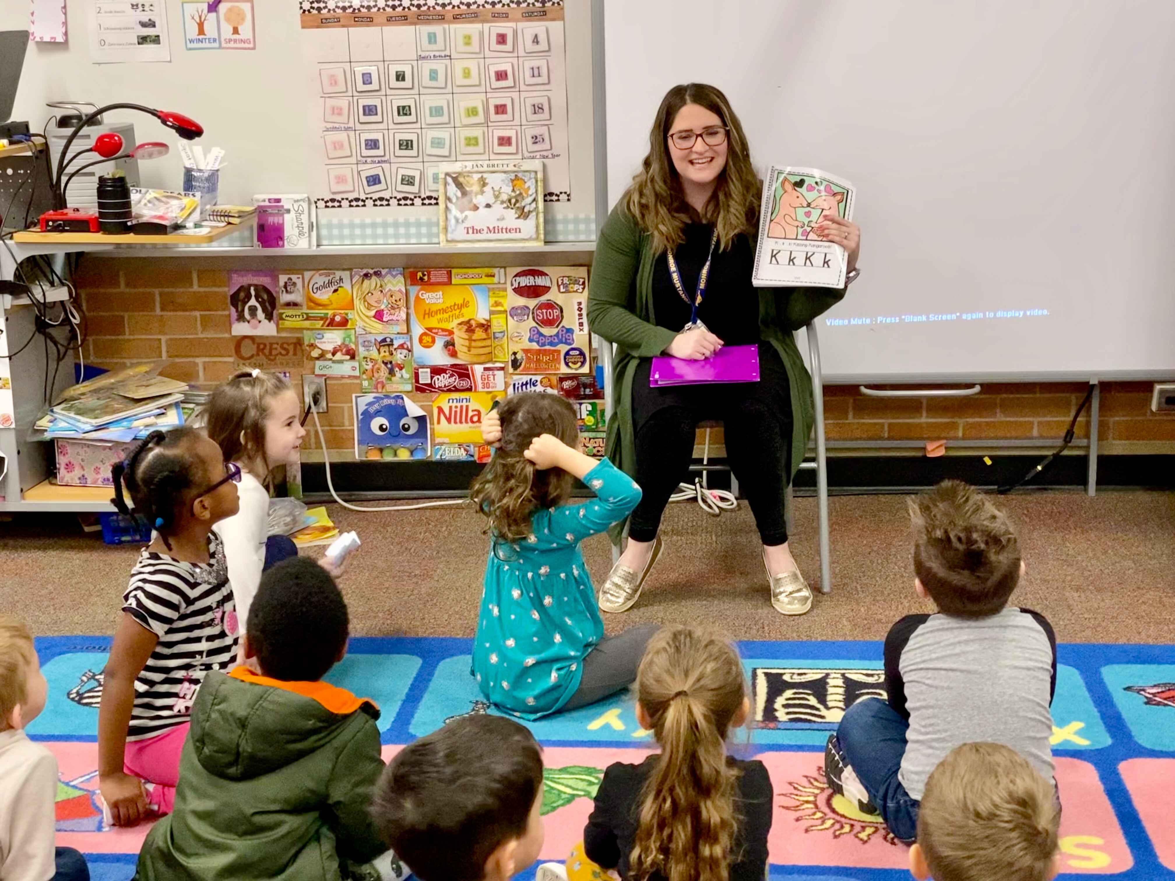 Teacher showing students a book