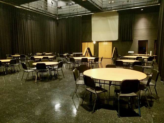 Empty studio theater with tables and chairs