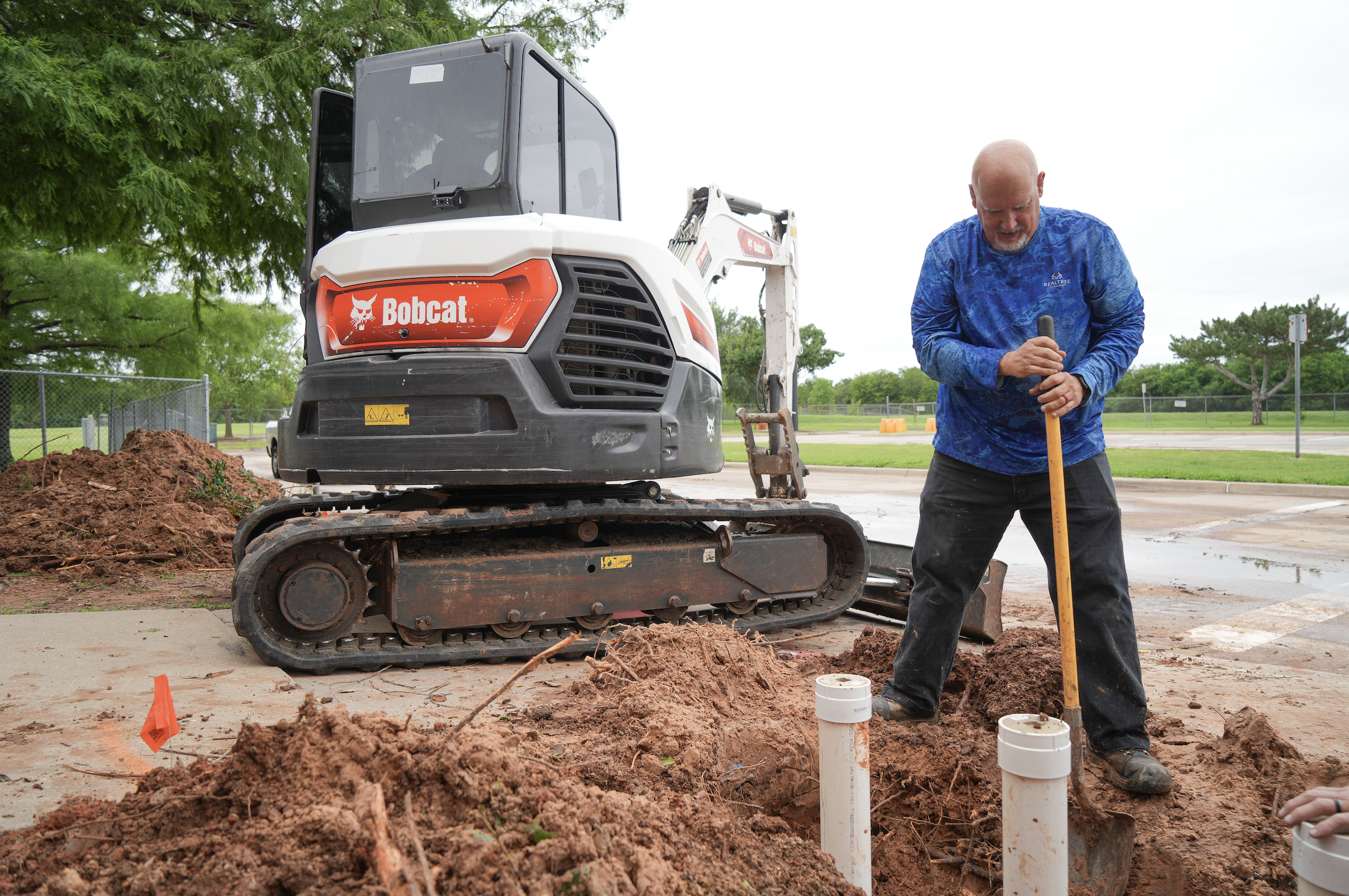 plumber working outside with heavy equipment