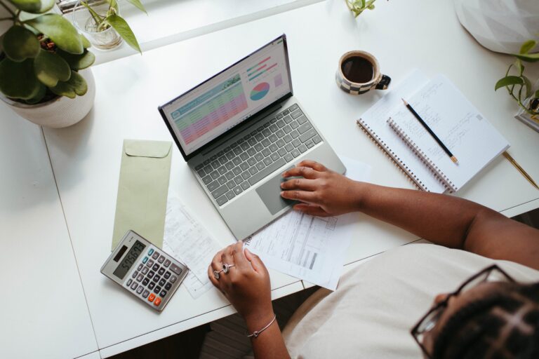 laptop and office supplies on top of a table