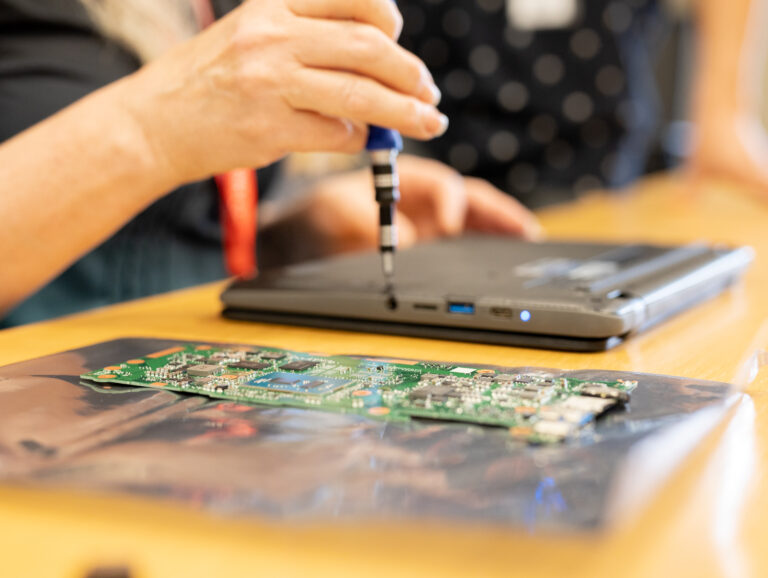 couple of hands working with a digital multimeter