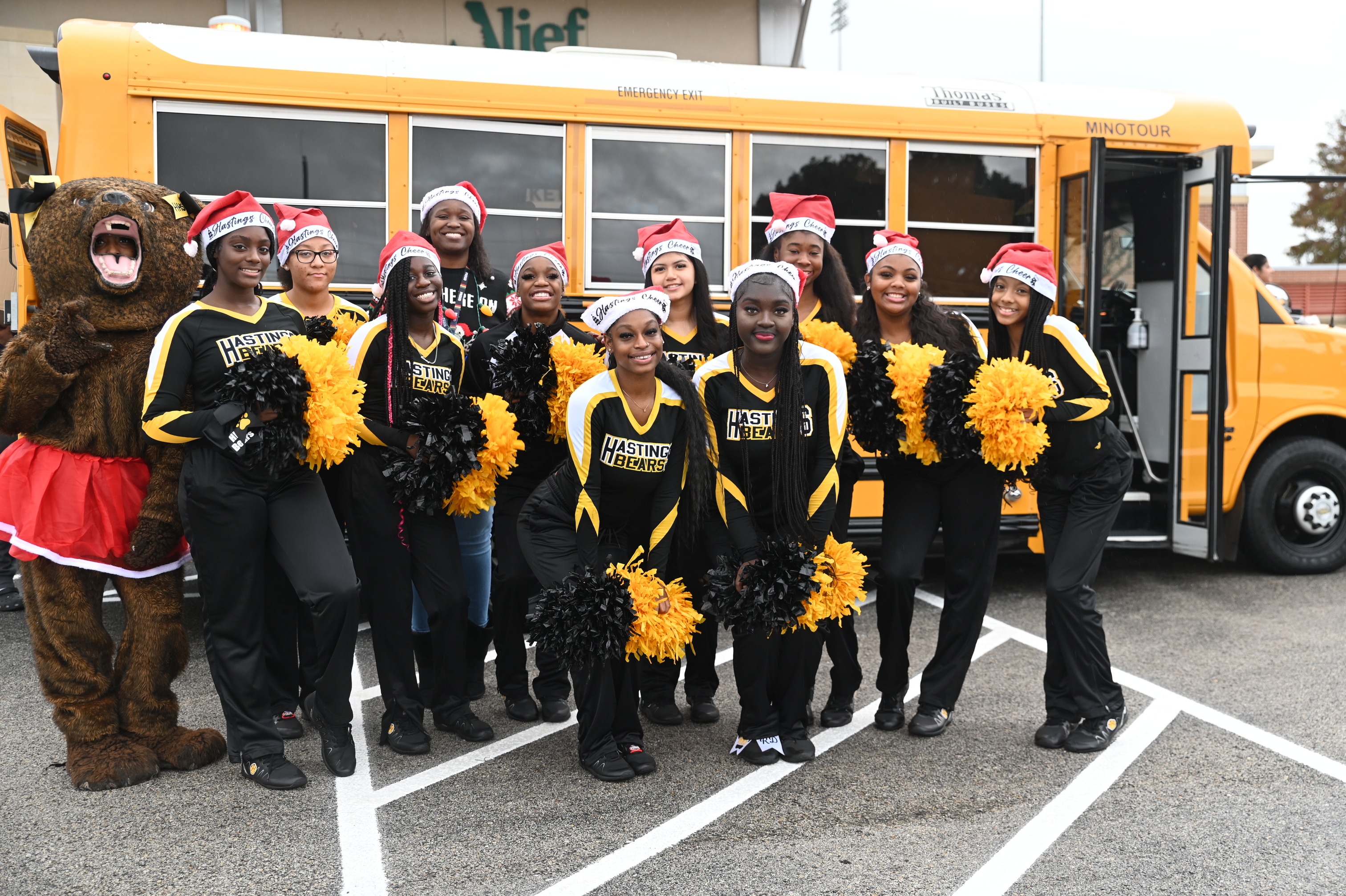Alief ISD cheerleaders, mascots, choir students, and sponsors support the annual Stuff-A-Bus by performing for community members and donating uniforms and school supplies for our pantry.