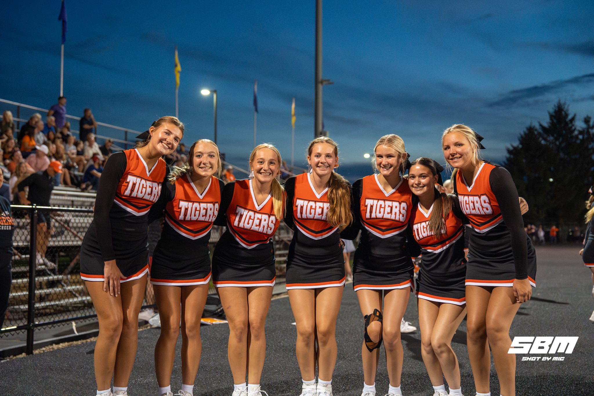 cheerleaders in uniform at a Friday night game