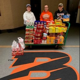 Byron B with three woman accepting food donation