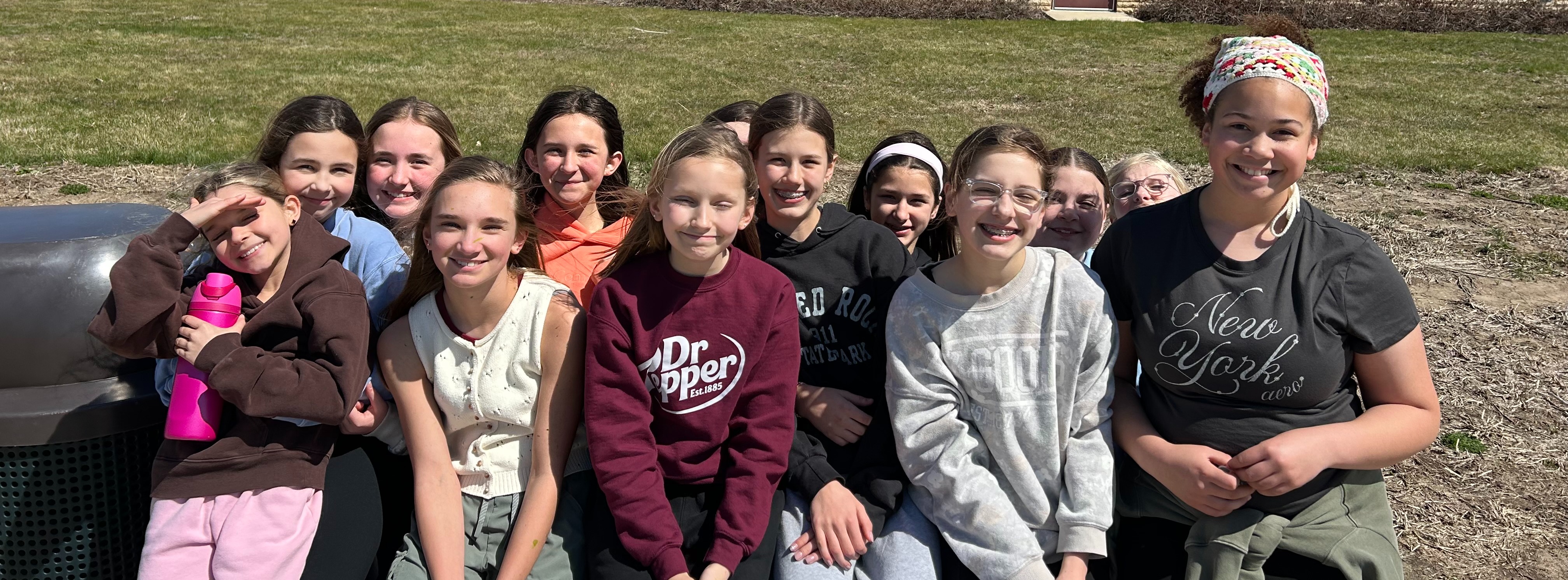 middle school girls hanging out on a bench