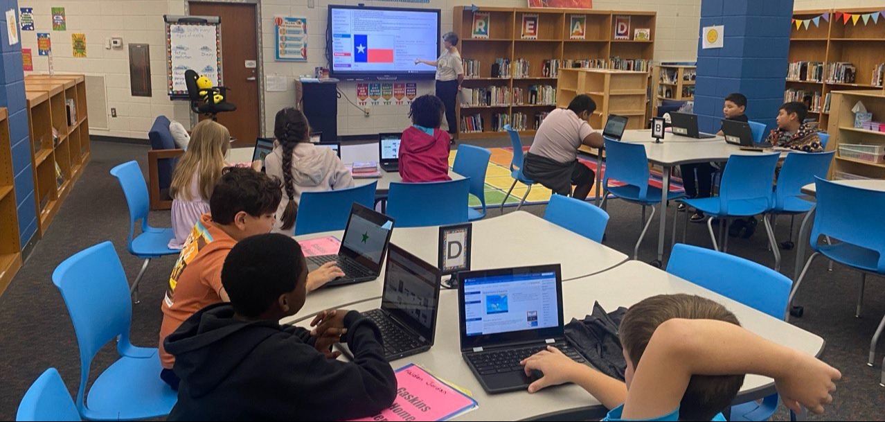 Students at Berry Shoals completing interactive lessons in the library