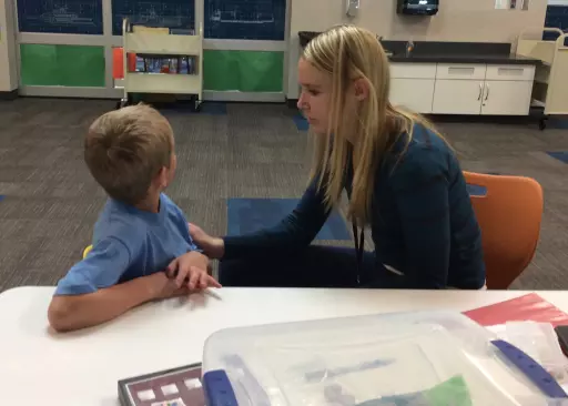 teacher is looking at the behavior of a student calmly