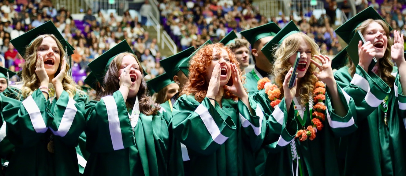 Clearfield students chanting fight song at graduation in caps and gowns