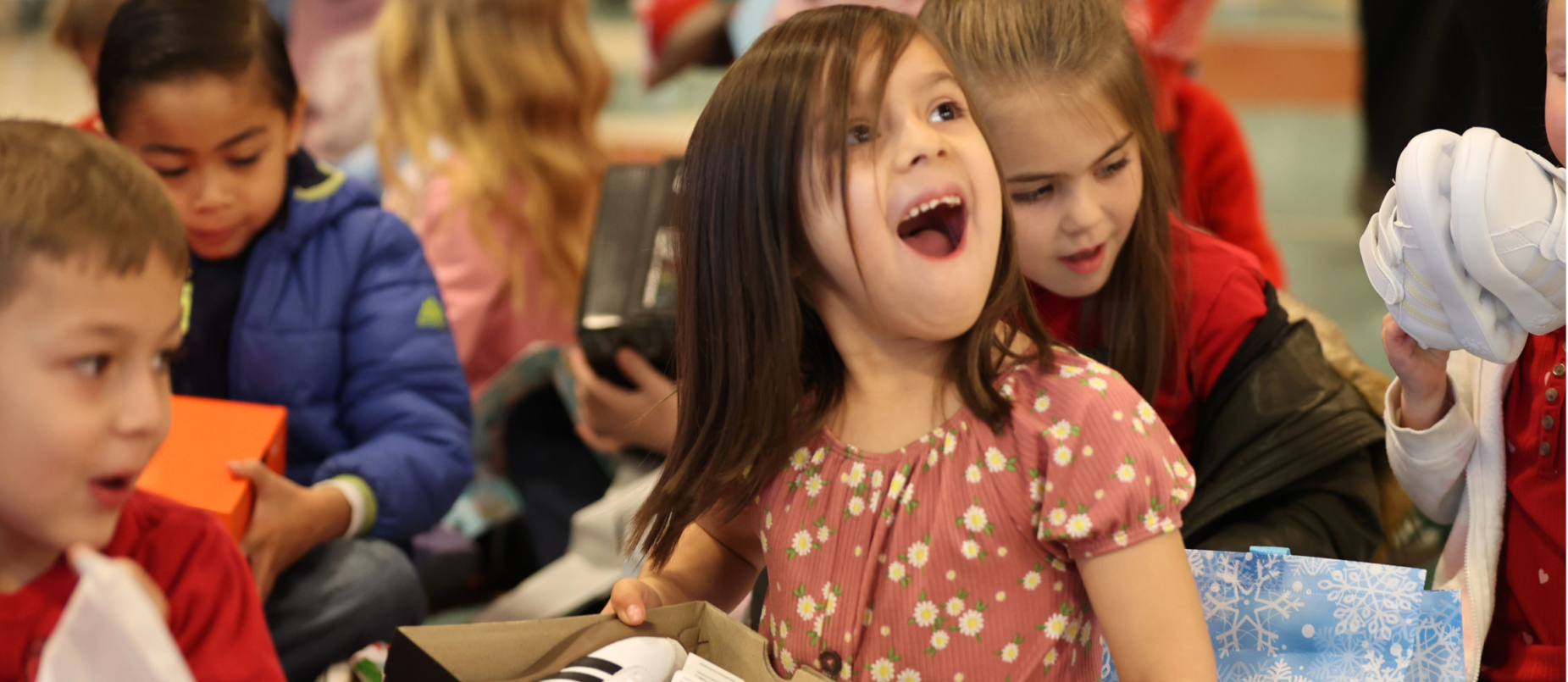Girl receiving shoes in Elves and the Shoemaker event