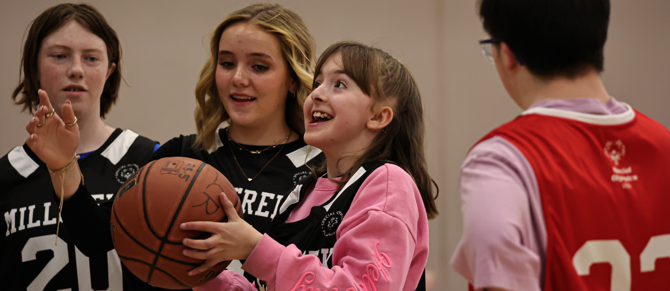Students playing during a basketball game.