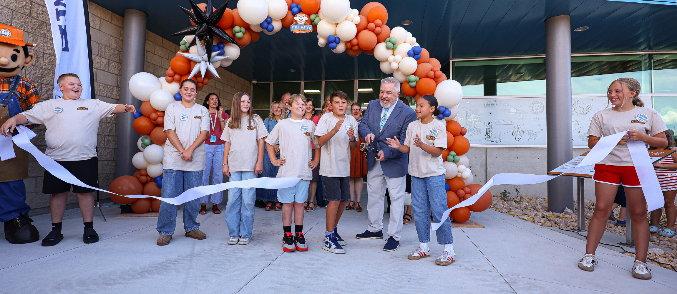 Students and admin excited while cutting the ribbon to officially open Still Water Elementary.