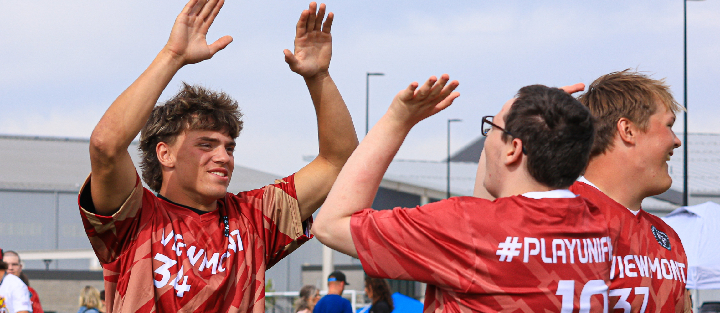 Students high fiving after making a goal.