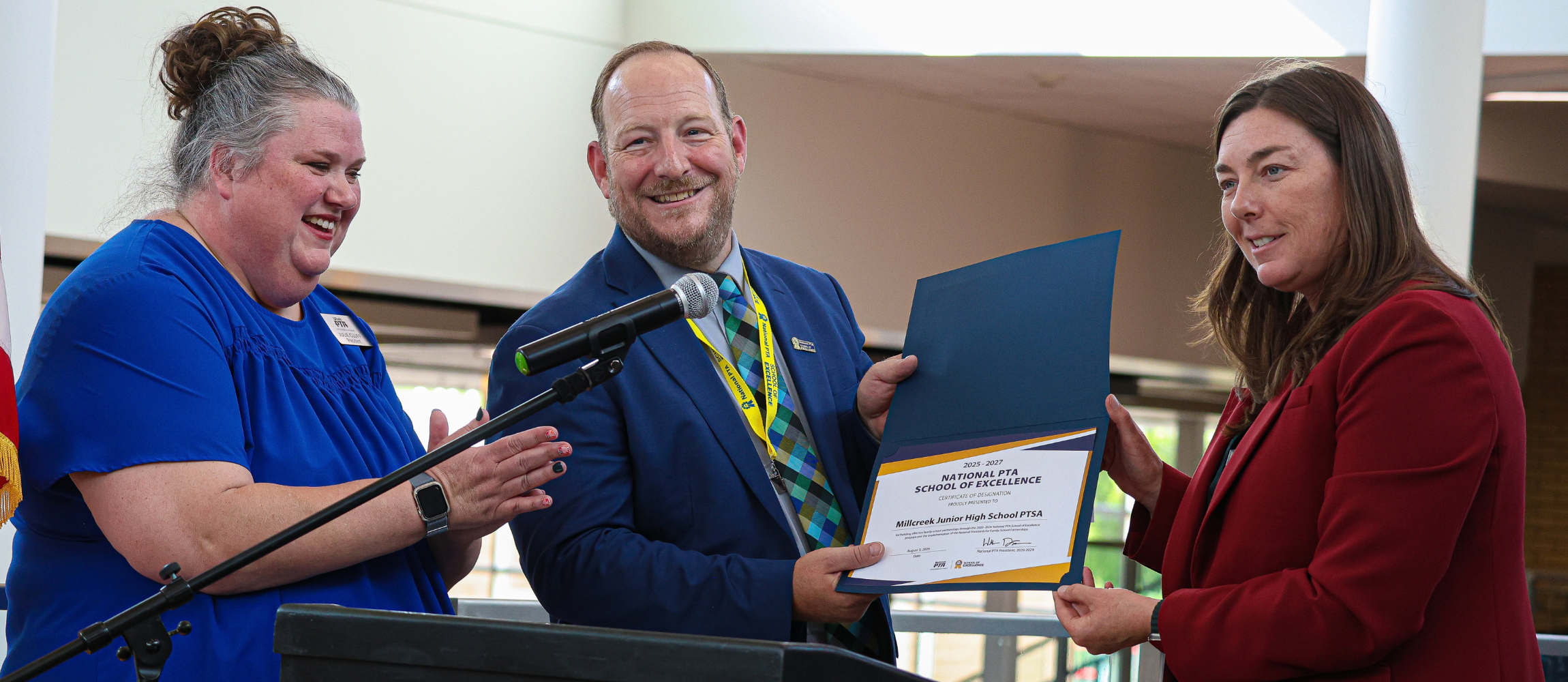 Utah PTA President and Bountiful City Mayor present Millcreek Junior High with PTA National School of Excellence award.