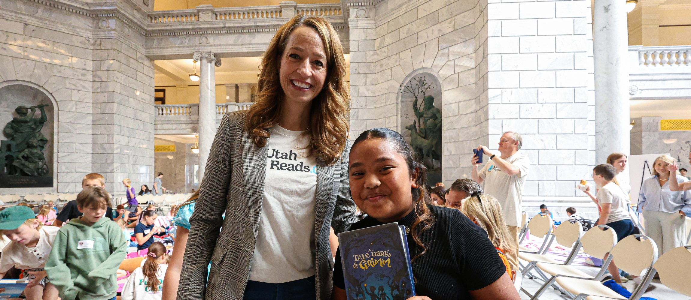Student and First Lady Abby Cox smiling while at the Utah Reads Read-A-Thon at the Utah State Capitol.