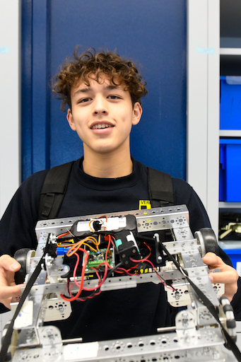 student holding his project