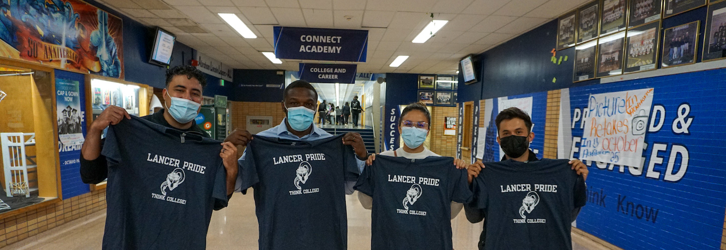 4 persons holding a t-shirt 