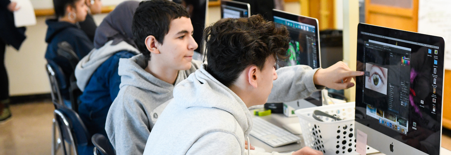 2 students working on their laptops 