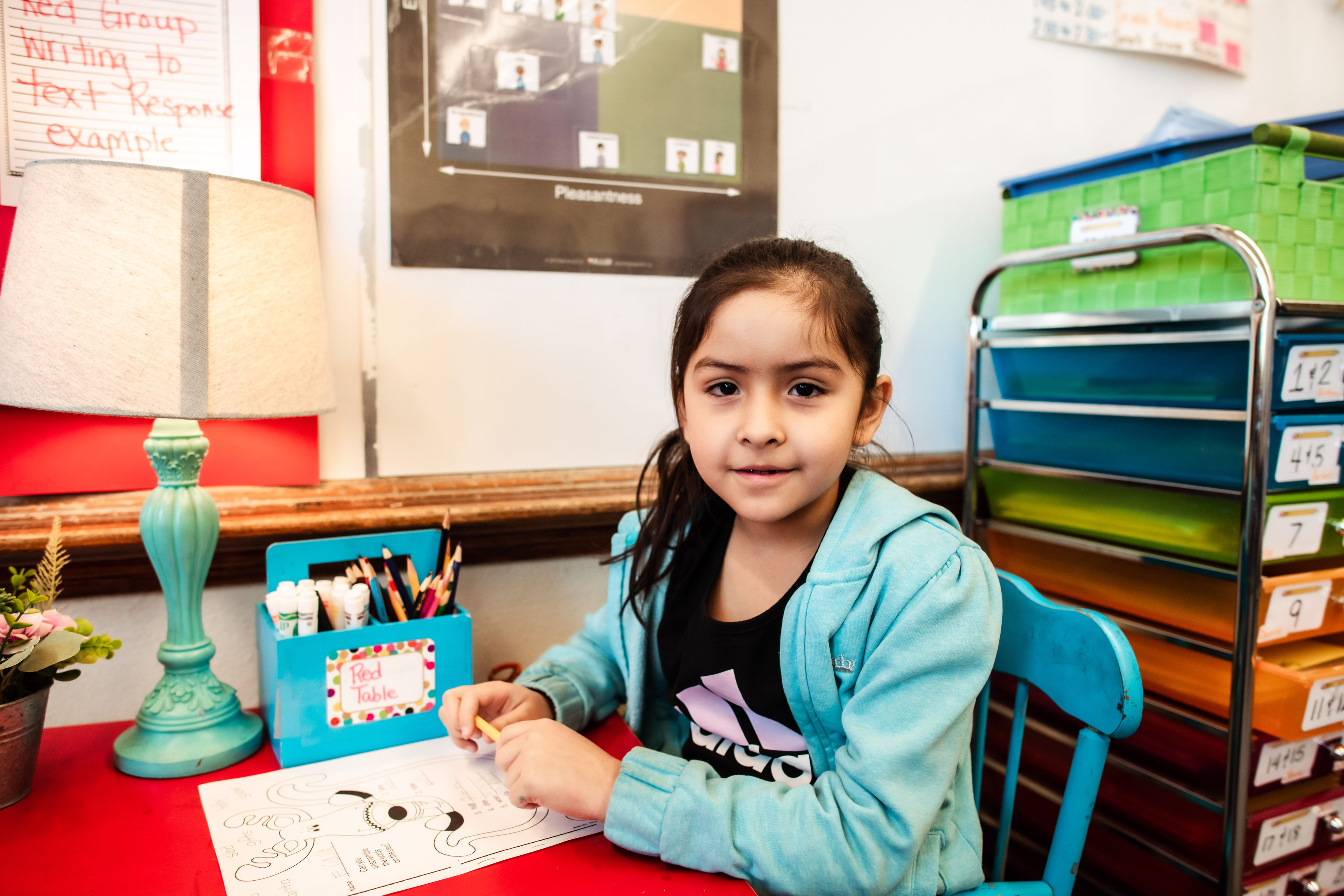 student smiling at desk