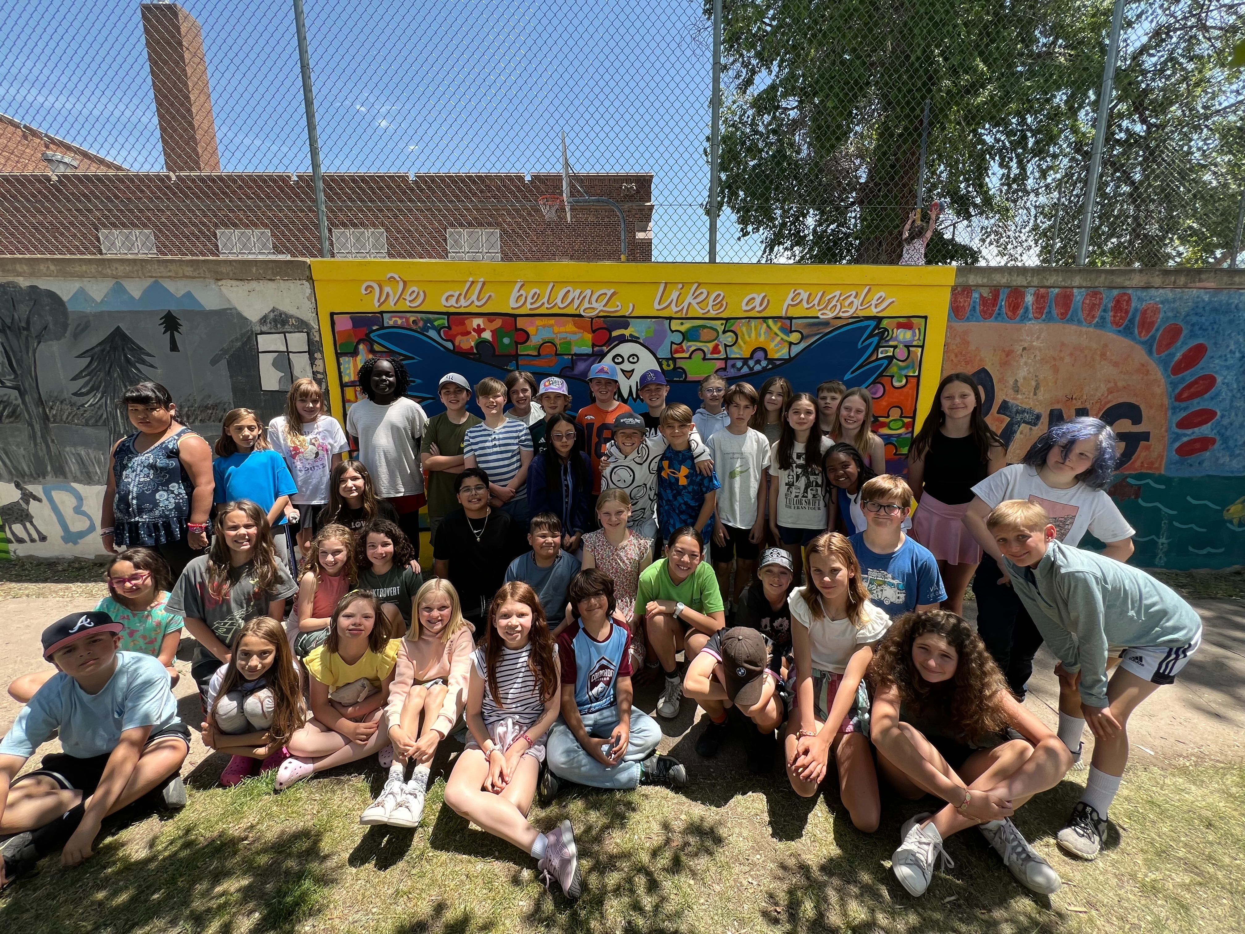 5th grade students in front of mural