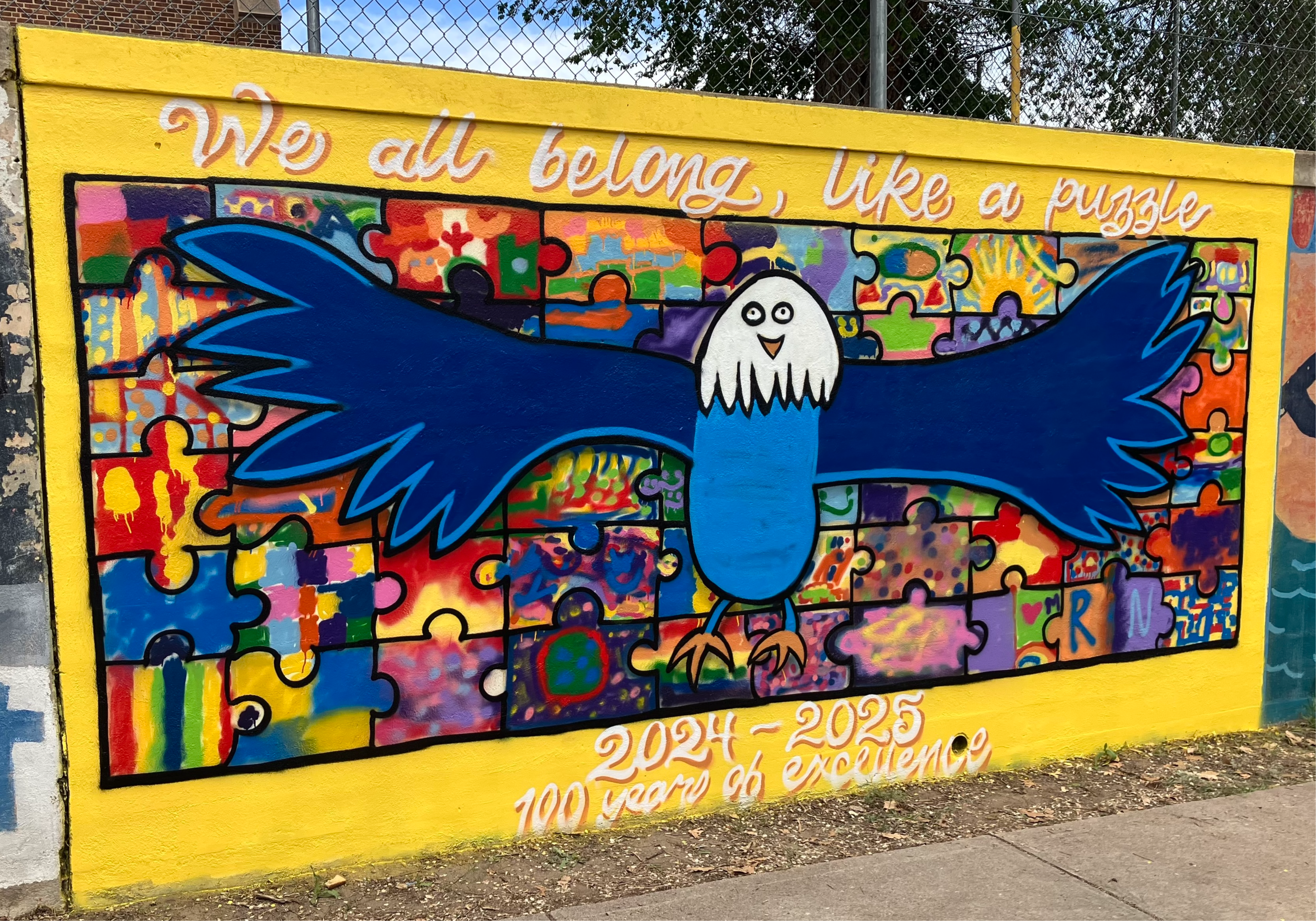 5th grade students in front of mural