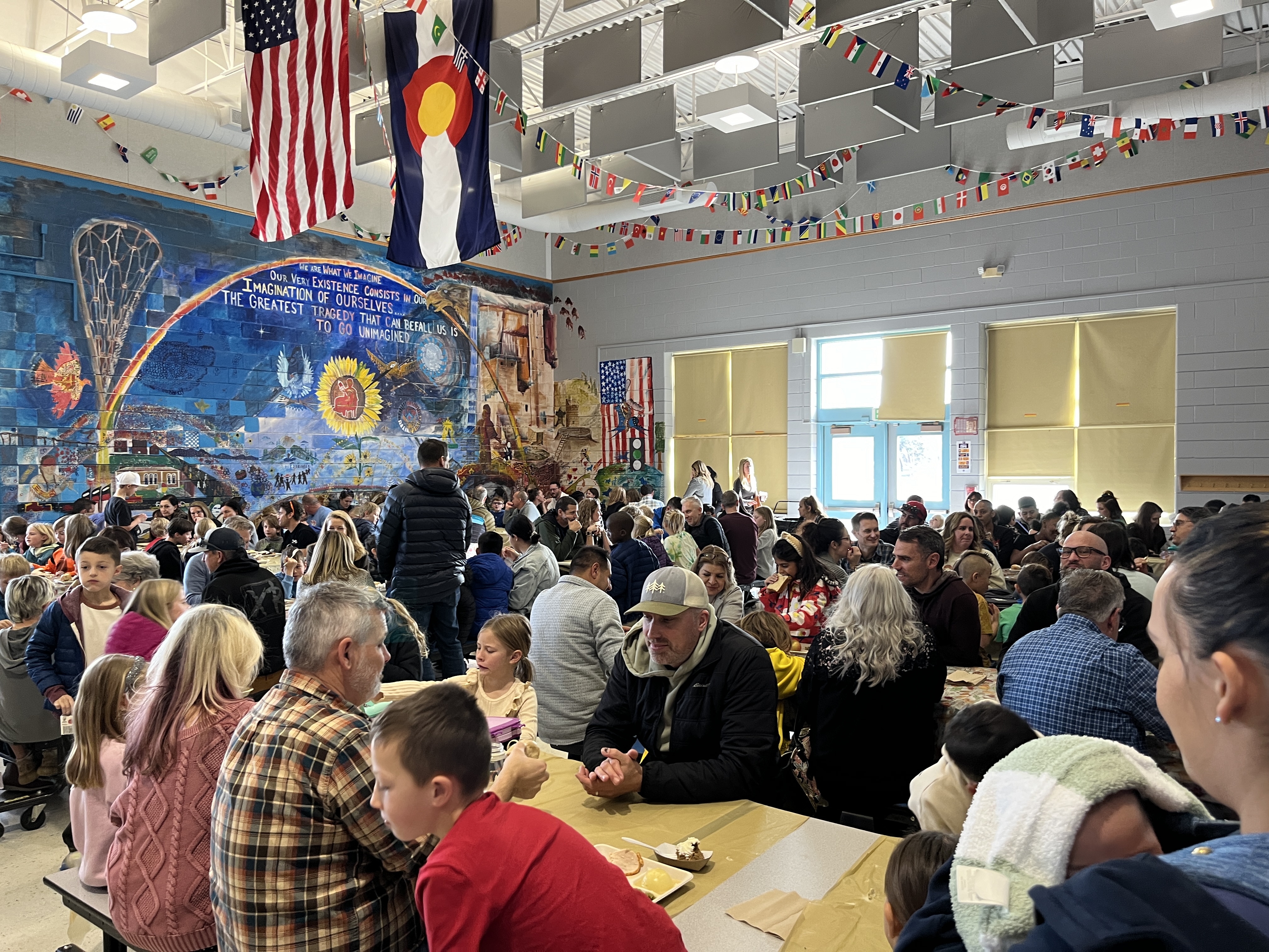 Families seated in the cafeteria at tables