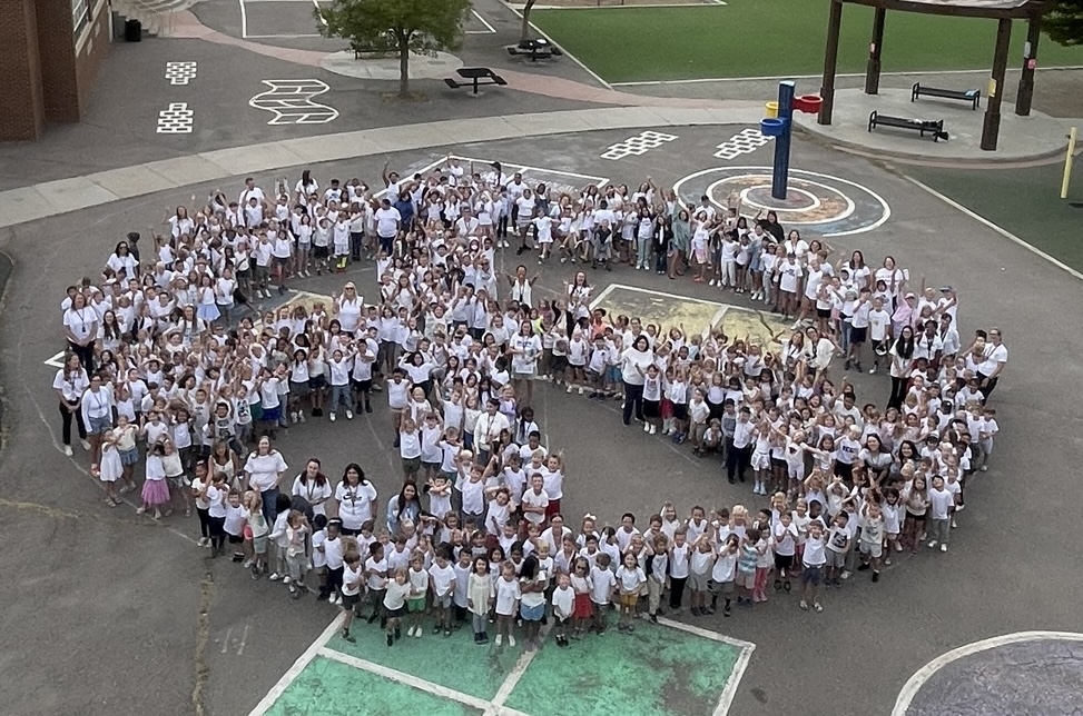 Students on the playground creating a peace sign