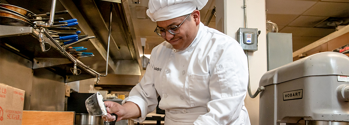 Culinary Arts teacher cooking at class